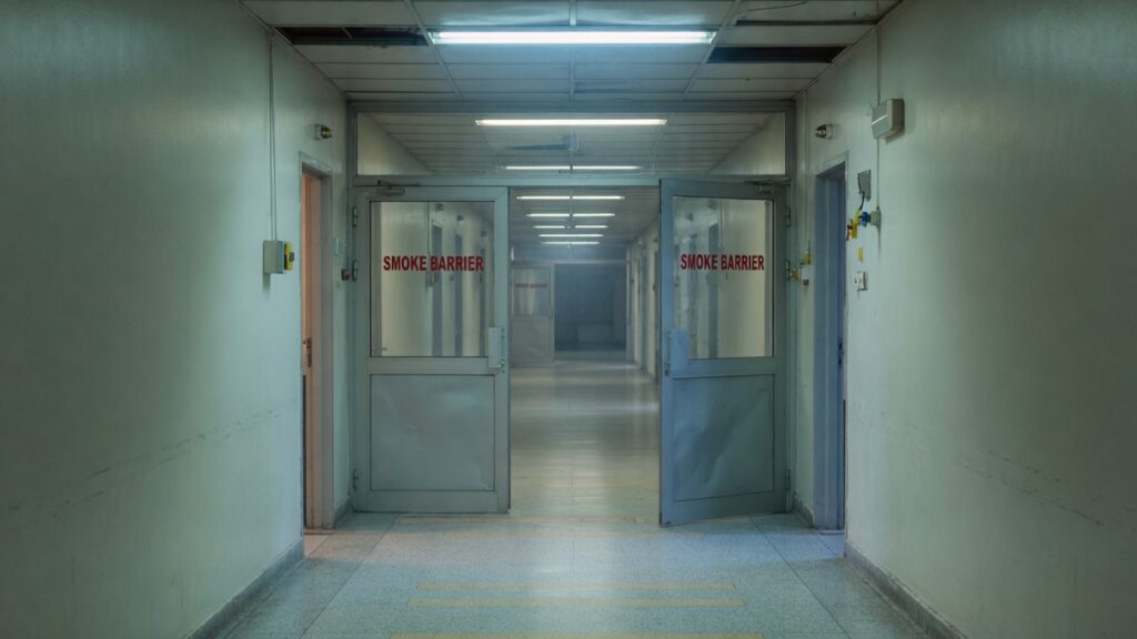 Long hospital corridor with smoke-barrier doors
